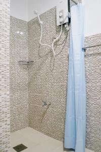 公主港Stylish 2-BR Transient Apartment in Prime Location的浴室内配有蓝色淋浴帘