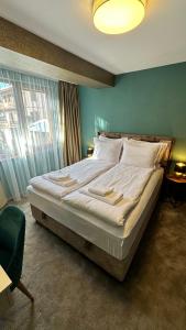 潘波洛沃ELEA Apartment Mountain Lodge Pamporovo的一间卧室设有一张大床和绿色的墙壁