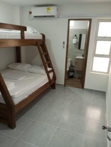 科韦尼亚斯Apartamento Villa Mary-Coveñas的一间带两张双层床的卧室和一间浴室