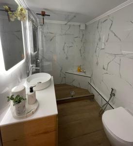 雅典Avant-Garde Studio的白色的浴室设有卫生间和水槽。