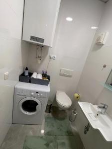 格拉茨JS Design Apartment的白色的浴室设有洗衣机和水槽。