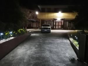 水户一棟貸しの宿 貸別荘 水戸ハウス Vacation Rental Mito House的夜间停在大楼前的汽车