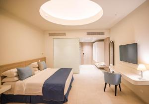 马萨阿拉姆SENTIDO Reef Oasis Suakin Resort的配有一张床和一台平面电视的酒店客房