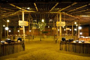 HunaywahAl Khayma Camp "Elite Camping & Dining in Experience"的大房间,谷仓里设有木桌