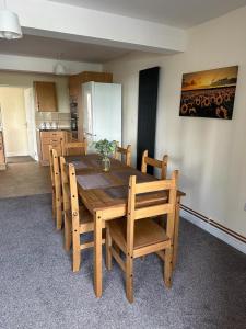 斯特劳德Lovely 2-Bed Apartment in Stroud的木制用餐室配有桌椅和厨房