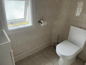 伦敦Comfortable Single Room Wembley Park/Stadium的一间带白色卫生间的浴室和窗户。