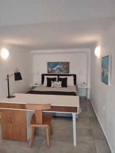 易莫洛林Amaze Suites的一间卧室配有一张床和一张木桌