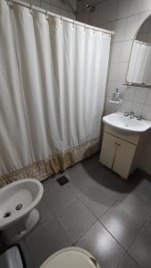 GualeguaychúLo de Silvia的浴室设有白色的淋浴帘和水槽
