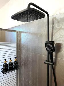 LazarétaInfinity Horizon Syros Apartment的浴室内配有带黑色淋浴喷头的淋浴