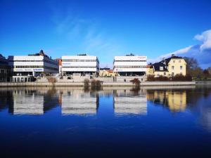 诺尔雪平Mysig lägenhet i City的一群建筑物,坐在水体旁边