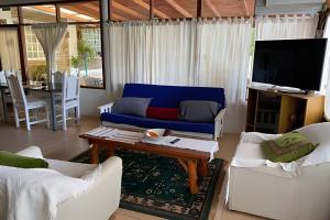 奥韦拉Cabañas con piscina en la entrada de Oberá的客厅配有蓝色的沙发和桌子