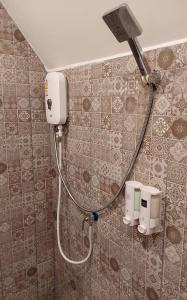 เรินนายหัว by KOYAD RESORT的浴室设有淋浴,墙上装有水管