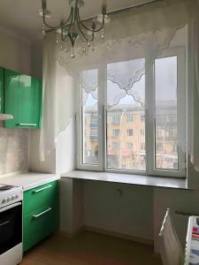 乌兰巴托VERY central location near State department store的厨房设有绿色橱柜和窗户。