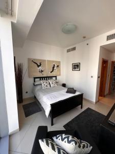 迪拜Amazing Double Room with En-suite, Marina and Sea views with shared kitchen的一间卧室配有一张床和一张沙发