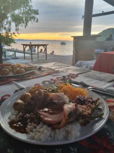 Cape Maclear图姆比景观山林小屋的餐桌上一盘带肉和米饭的食物