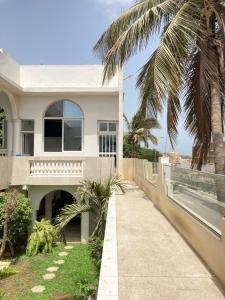 达喀尔Studio cosy sur la corniche的海滩上一棵棕榈树的房子
