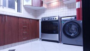 迪拜BEAUTIFUL VACATION HOME AT DUBAI BY MAUON TOURISM的厨房配有洗衣机和洗衣机。