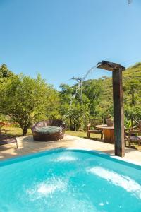 萨纳Peniel do Sana Guest House的庭院内的游泳池,带野餐桌