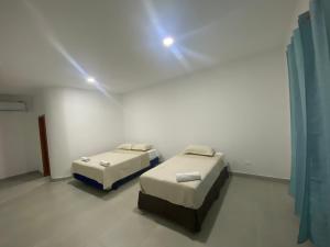 比亚米尔港Penguin House的墙上灯的房间里设有两张床