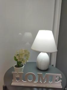 海若克利欧Grey Sense Luxury Apartment的一张桌子,上面有台灯和标志,上面写着家喻户晓