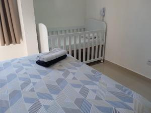 莫日-达斯克鲁济斯Apartamento completo A42 Flat Centro的卧室内的一张带婴儿床的床