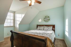 费耶特维尔Lovely Fayetteville Home Deck and Fireplace!的一间卧室配有一张床和吊扇