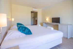 卡斯卡伊斯艾斯特勒姆查欧酒店的卧室配有白色床和蓝色枕头