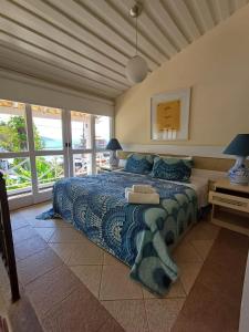 布希奥斯Porto Mar de Búzios的一间卧室配有一张带蓝色棉被的床