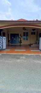 CukaiNinizam Kemaman Cukai Homestay的一个小房子,设有门廊和车道
