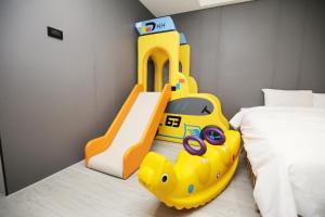 斗六市云林斗六太信大饭店的儿童卧室配有黄色潜艇滑梯和床