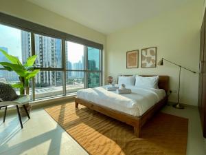 迪拜Cosy & Spacious 2 BR l Magical Boulevard View l by Burj & Dubai Mall I Pool I Gym I Family friendly的一间卧室设有一张床和一个大窗户