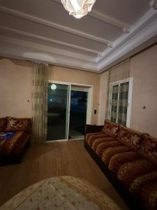 杰迪代Holikeys - El jadida - 2 Ch - Sidi Bouzid 001的带沙发和窗户的客厅