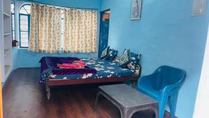 布什格尔GUEST HOUSE INN的一间小卧室,配有一张床和蓝色的墙壁