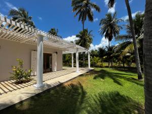 MaxaranguapeMaracajau Luxury Home - Villa-Mar-a-Villa的白色凉亭和棕榈树度假屋