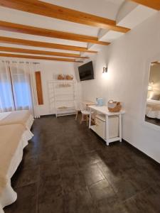 菲内斯特拉特Villa Morena的一间卧室配有一张床、一张书桌和一台电视。