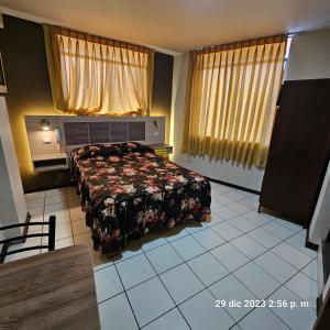 利马瀑布酒店的一间卧室配有一张带花卉床罩的床