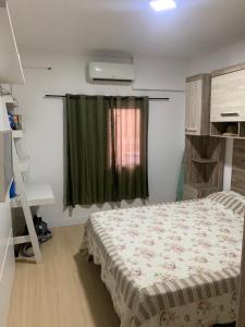 大普拉亚Casa com churrasqueira Guilhermina Praia Grande的一间卧室配有床和绿帘