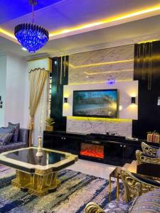 IkuataLuxury Charming 5Bed Duplex With Starlink wifi - Lekki的客厅设有壁炉和电视。
