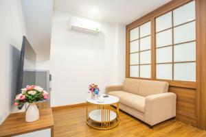 河内Sumitomo 15 Apartment - No 27 Lane 39 Linh Lang Street的客厅配有椅子和桌子