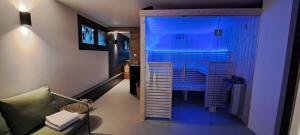 勒蒙多尔Alti'Pic Hôtel的一间设有蓝色灯光淋浴的客房