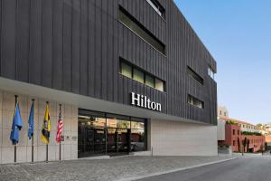 加亚新城Hilton Porto Gaia的前面有三面旗帜的建筑