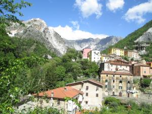 维亚雷焦Mobile home / Chalet Viareggio - Camping Paradiso Toscane的山丘上的小镇,以山丘为背景