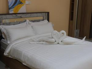 图鲁斯杜Tropical stay Thulusdhoo的一张带两个天鹅的毛巾床