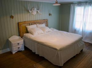 法伦Scoutstugan & Bagarstugan的卧室配有一张带白色棉被的大床