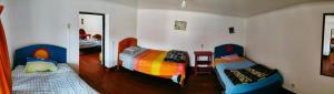 库斯科Hostel Rivendell的客房设有两张单人床和一面镜子