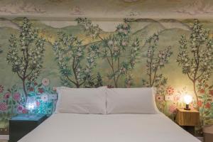 米兰莫斯科瓦豪华住宿加早餐旅馆的一间卧室配有一张带花卉壁纸的床