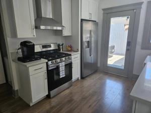 长滩Entire home in Historic Long Beach close to shops的厨房配有炉灶和冰箱。