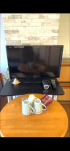 东京平和岛民宿的一张桌子,上面放着两个咖啡杯,还有一台电脑显示器