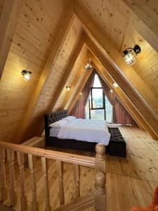 斯库台Windmill Shkodra Gesthouse Camping & Grill的小木屋阁楼上的一张床位