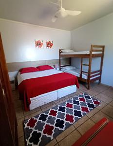 伊瓜苏POUSADA EVELINA的一间卧室配有一张带红色毯子和地毯的床。